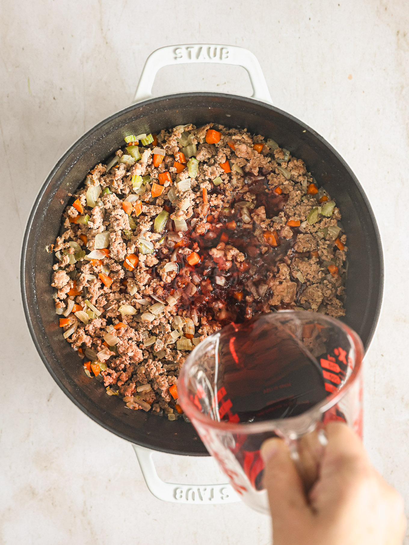 wine with cooked vegetables and ground meat.