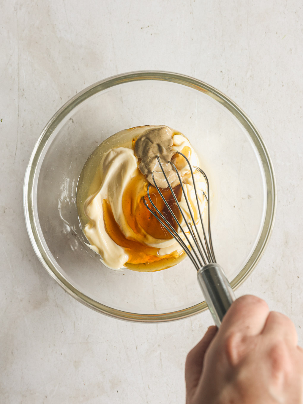dressing whisked in a glass bowl.