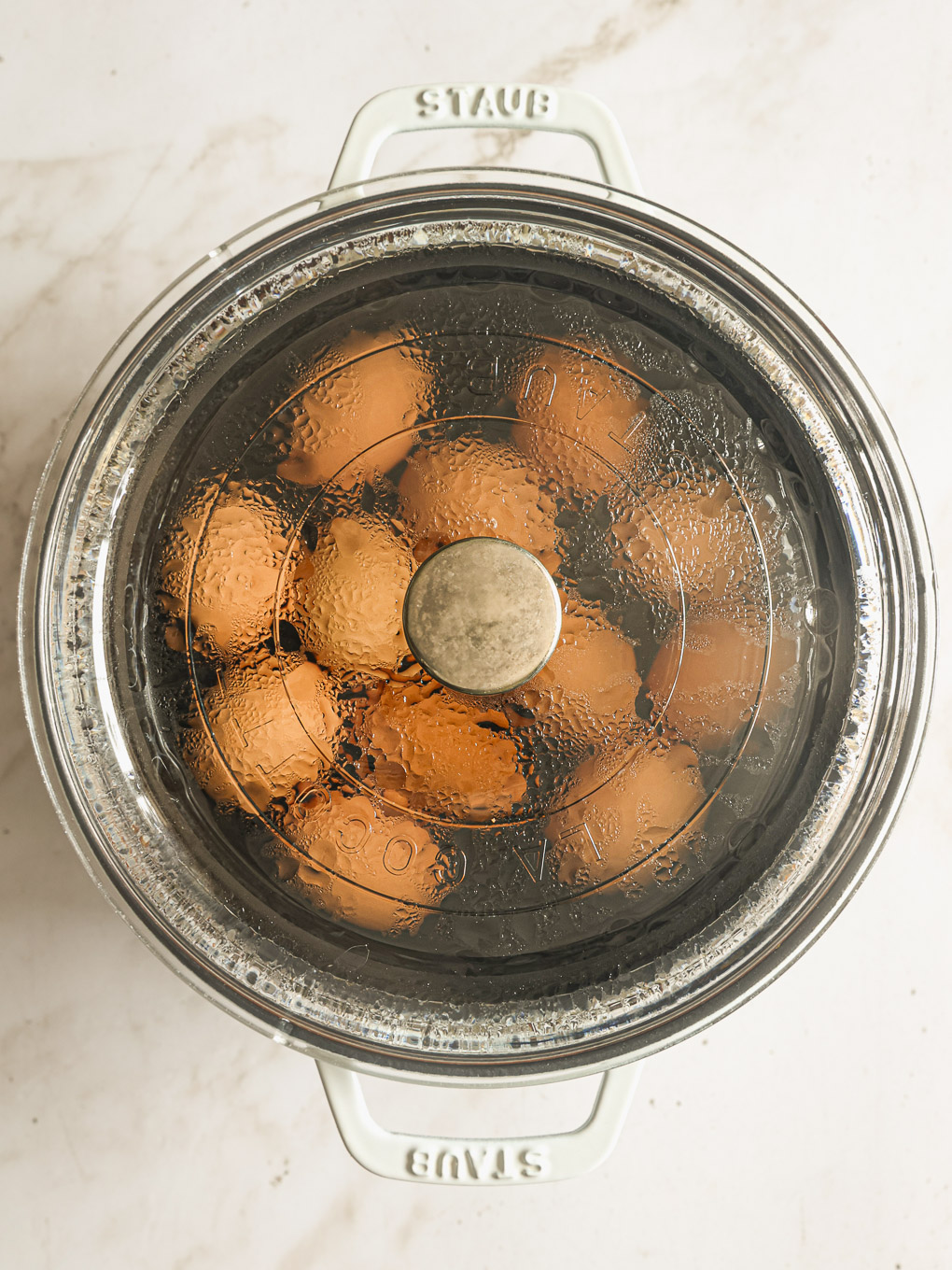 eggs boiling in a pot.