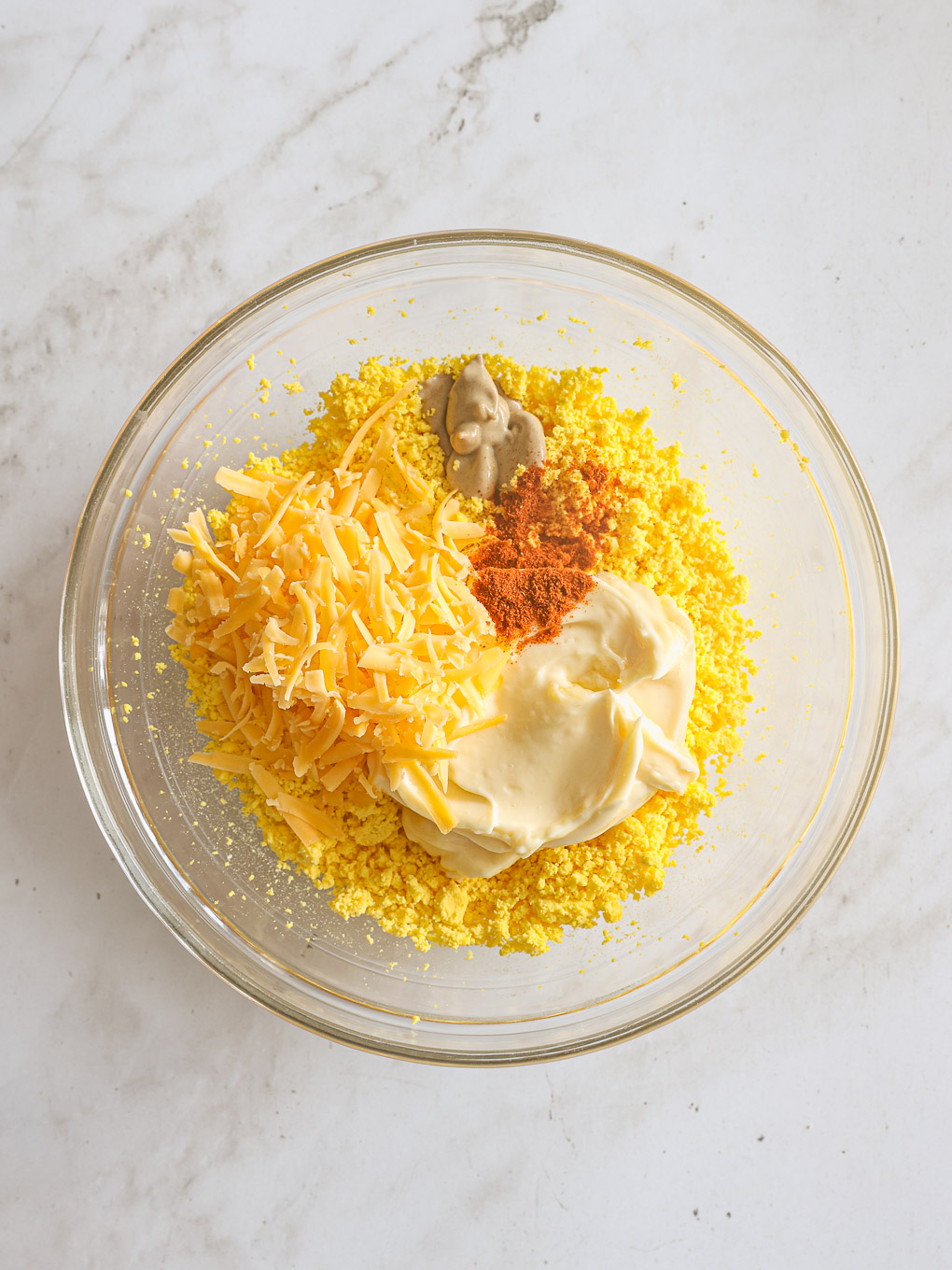 deviled eggs filling in a glass bowl.
