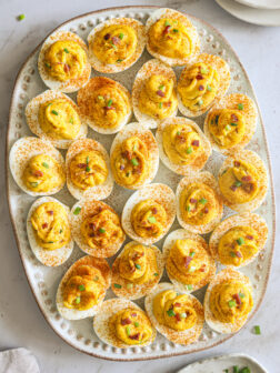 deviled eggs on a white platter.