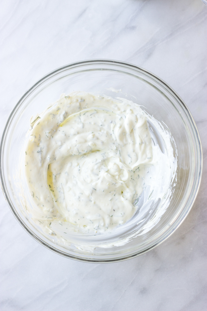 yogurt dill dip in a glass bowl.