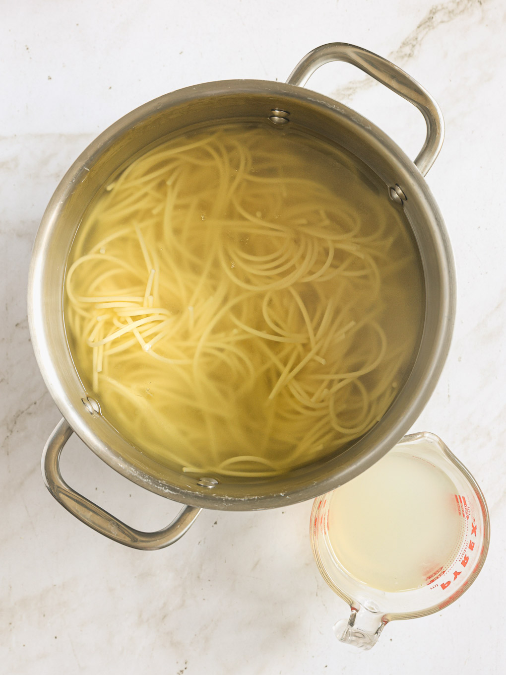 cooked spaghetti in a pot of water.