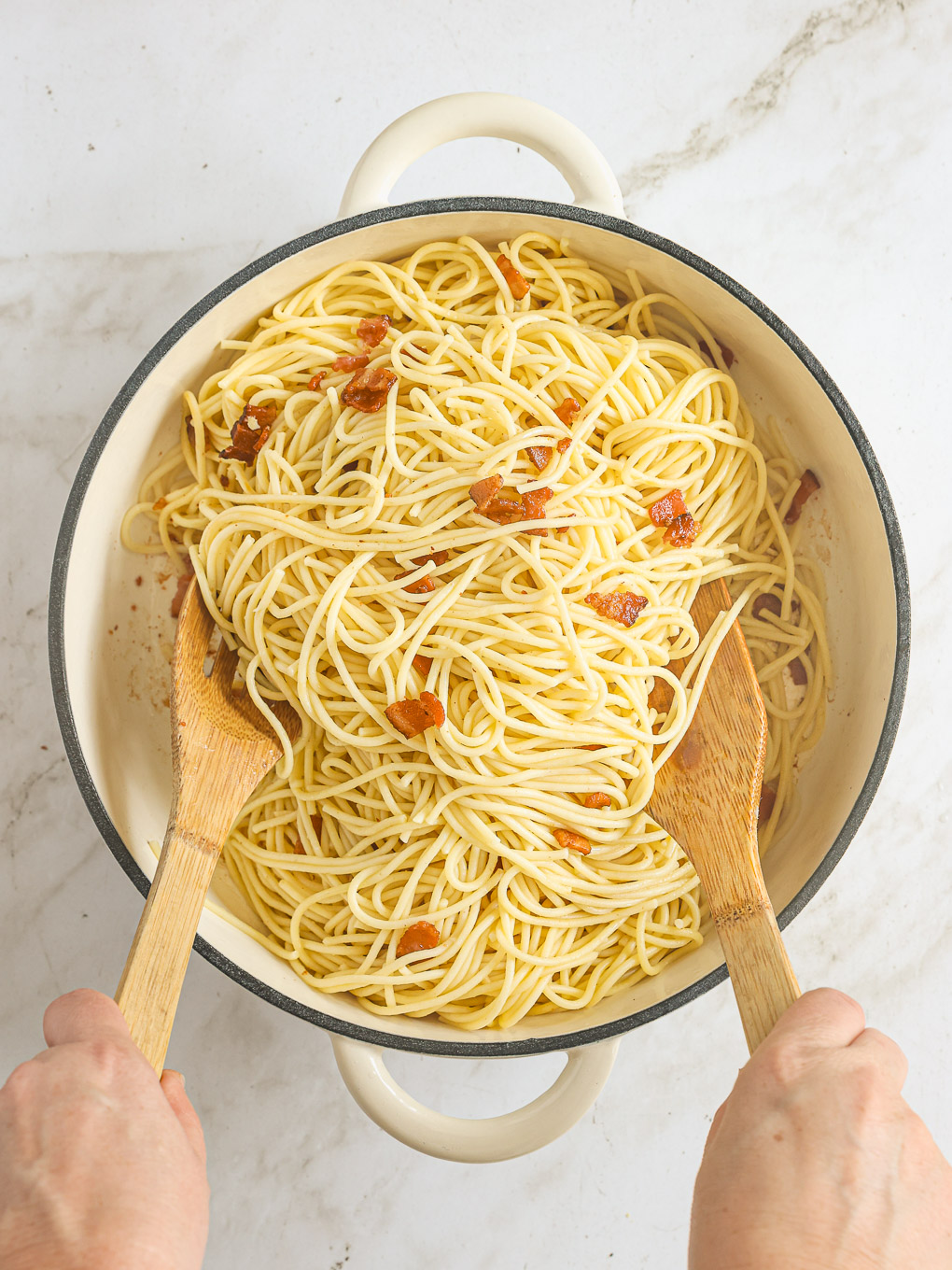 cooked spaghetti tossed with cooked bacon.