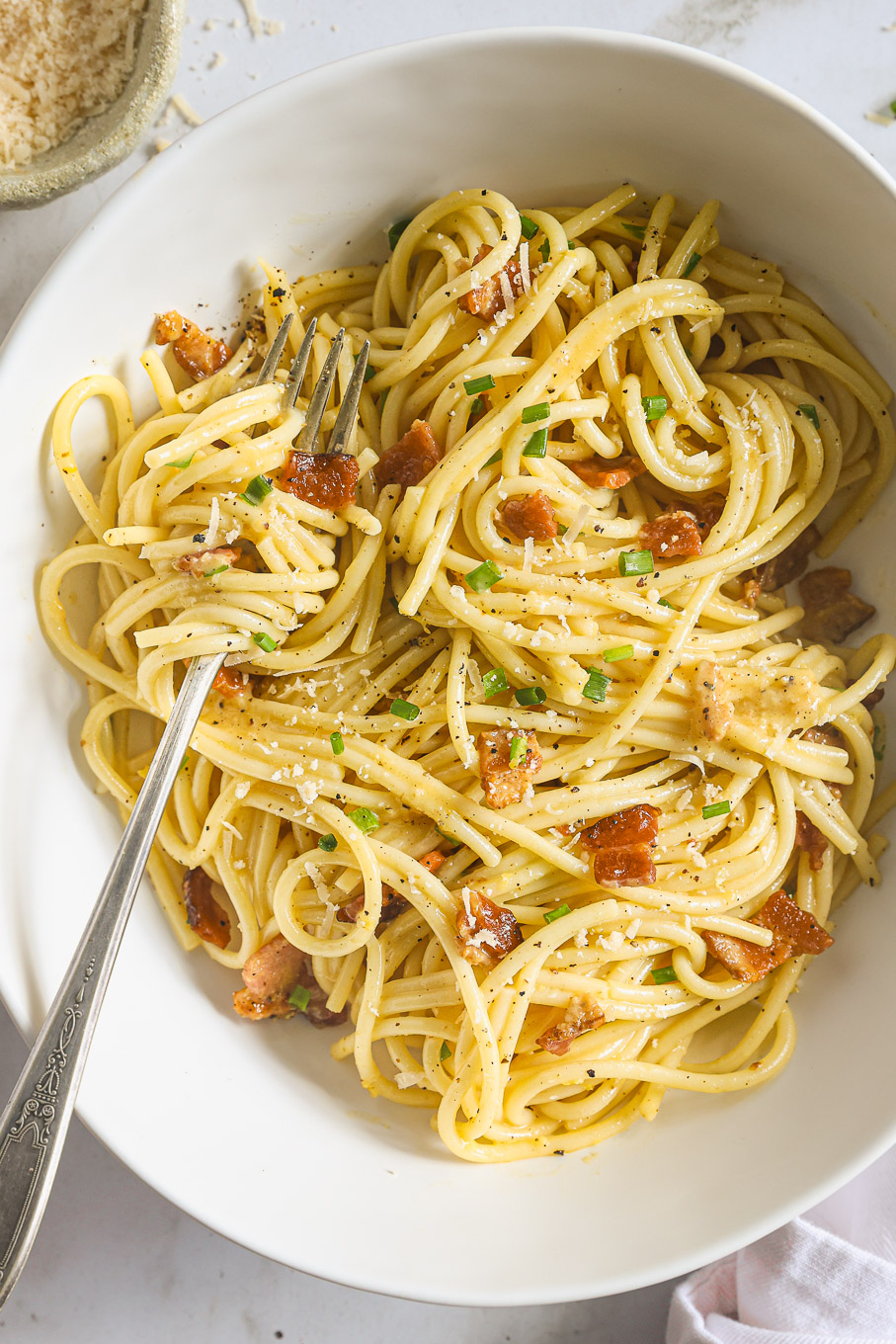 spaghetti carbonara in a bowl with a fork.