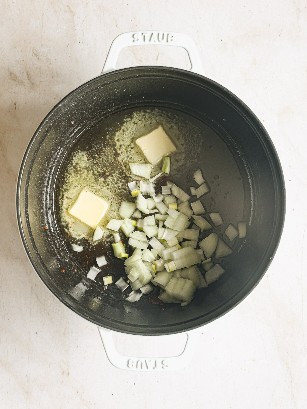 diced onions and butter in a pot.