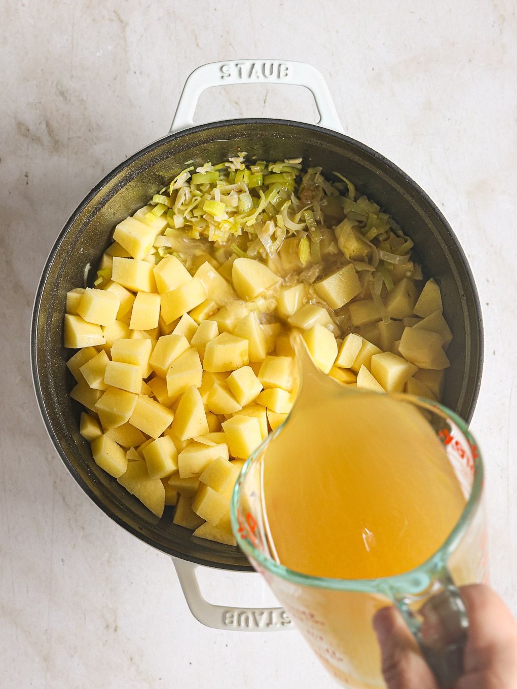 diced potatoes with broth in a pot.