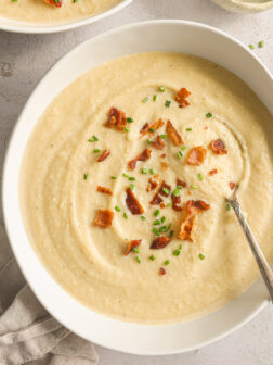 potato leek soup in a white bowl.