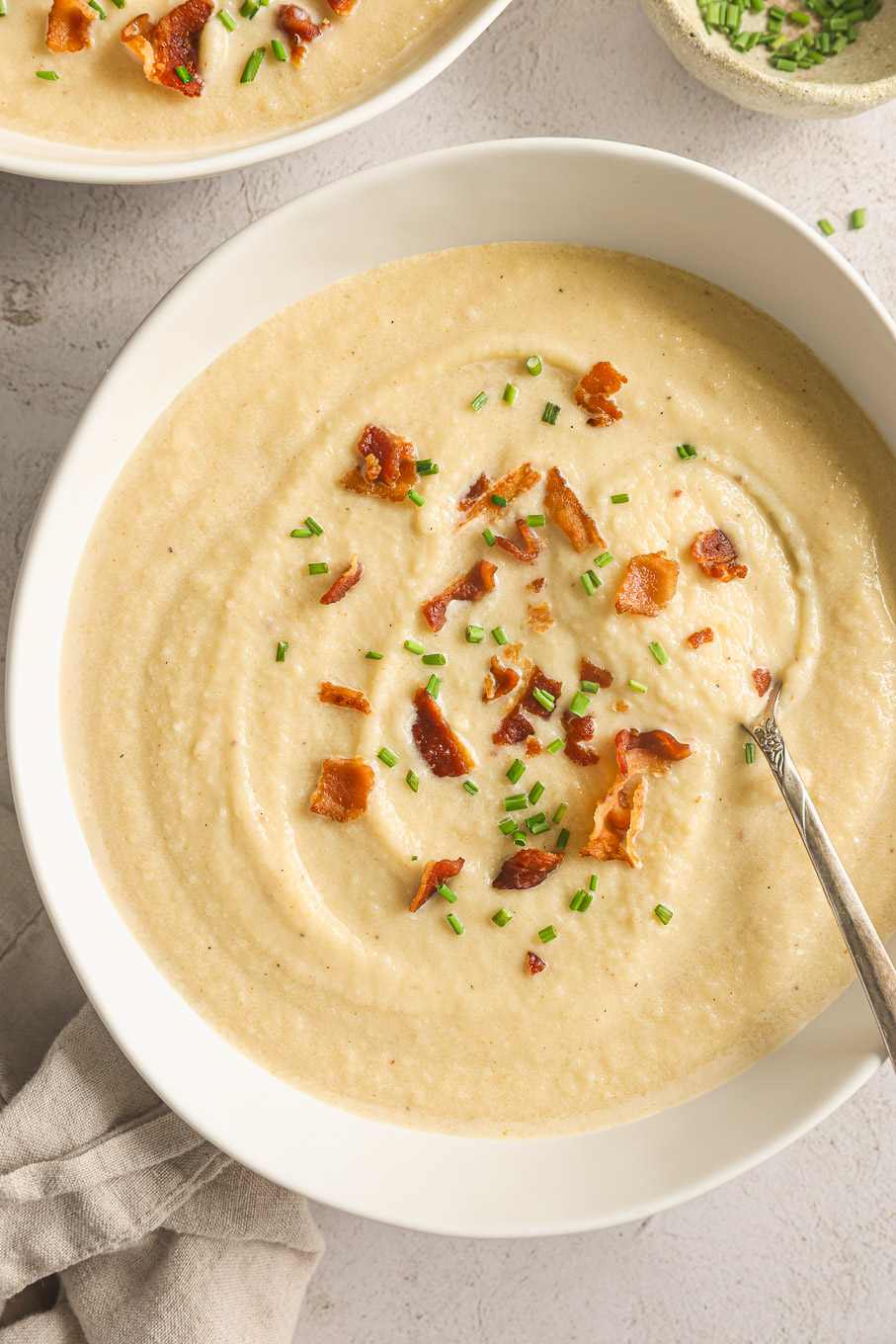 potato leek soup in a white bowl.