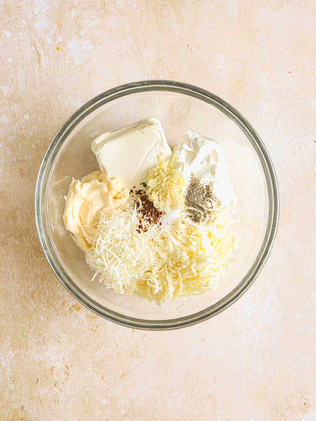 cream cheese and cheeses in a glass bowl.