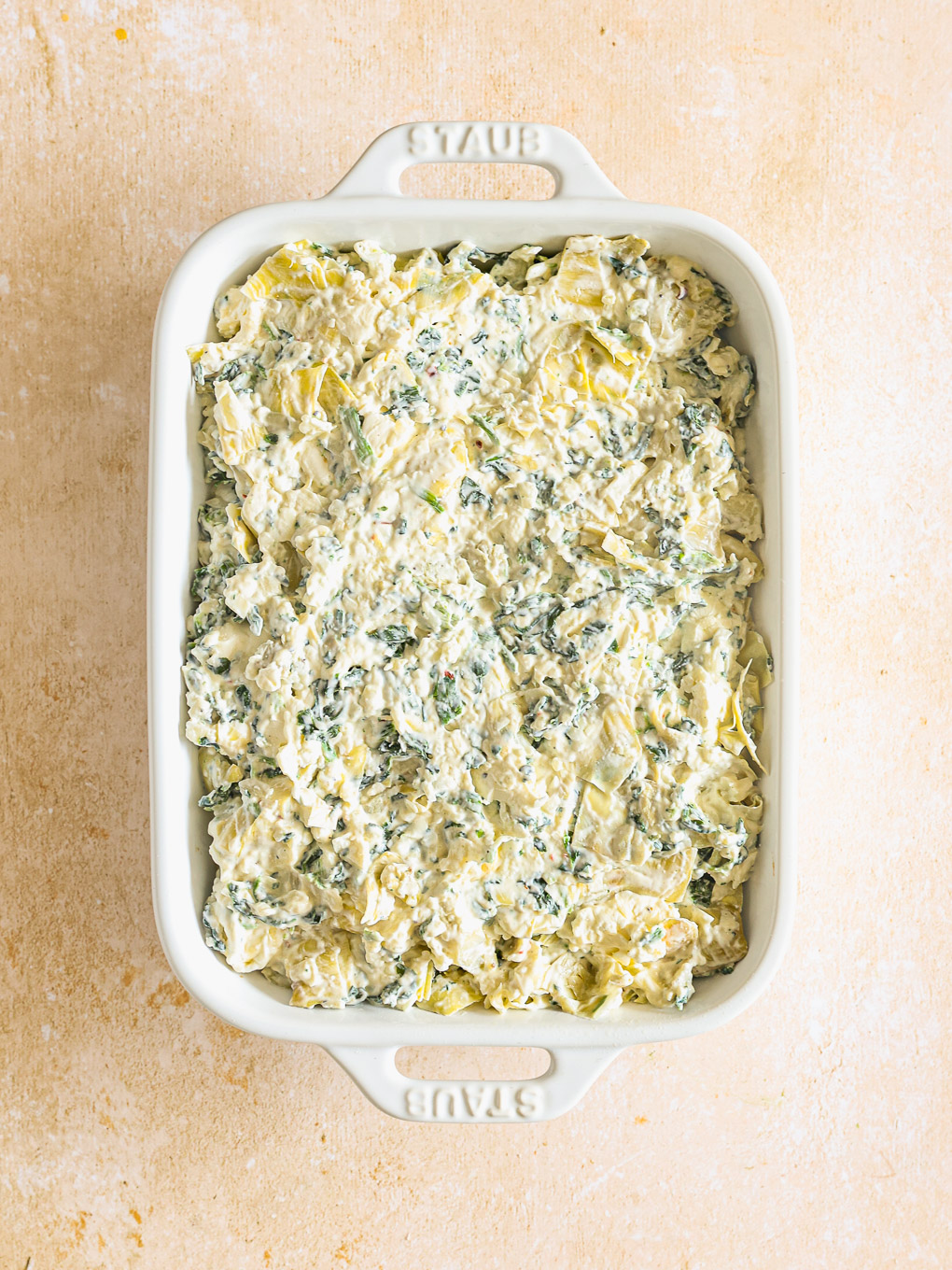 artichoke dip in a baking dish.