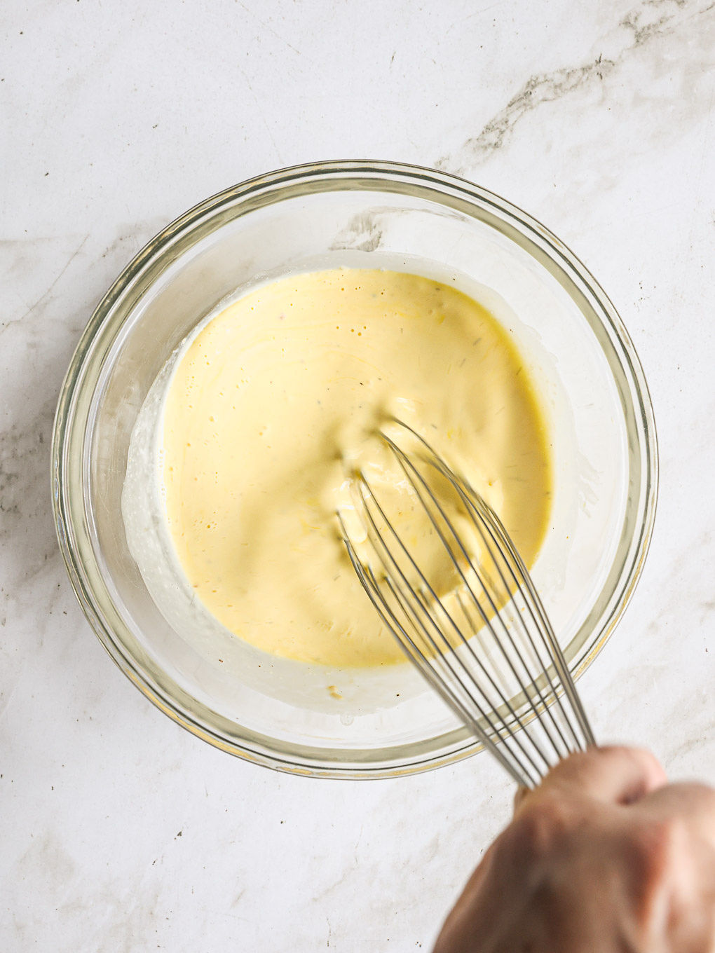 whisked eggs in a glass bowl.