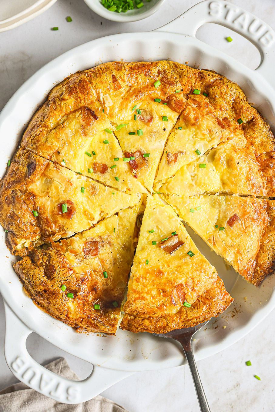 sliced crustless quiche in a baking dish.