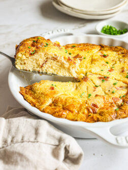 side view of breakfast quiche in a baking dish.