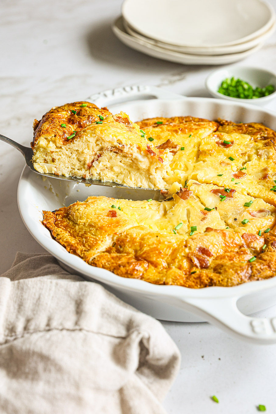 side view of breakfast quiche in a baking dish.