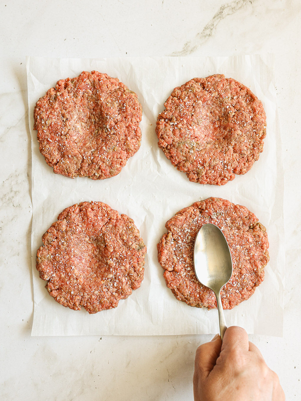 beef patties with indent in the middle.