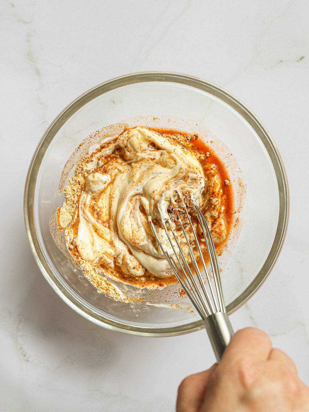 dressing whisked in a glass bowl.