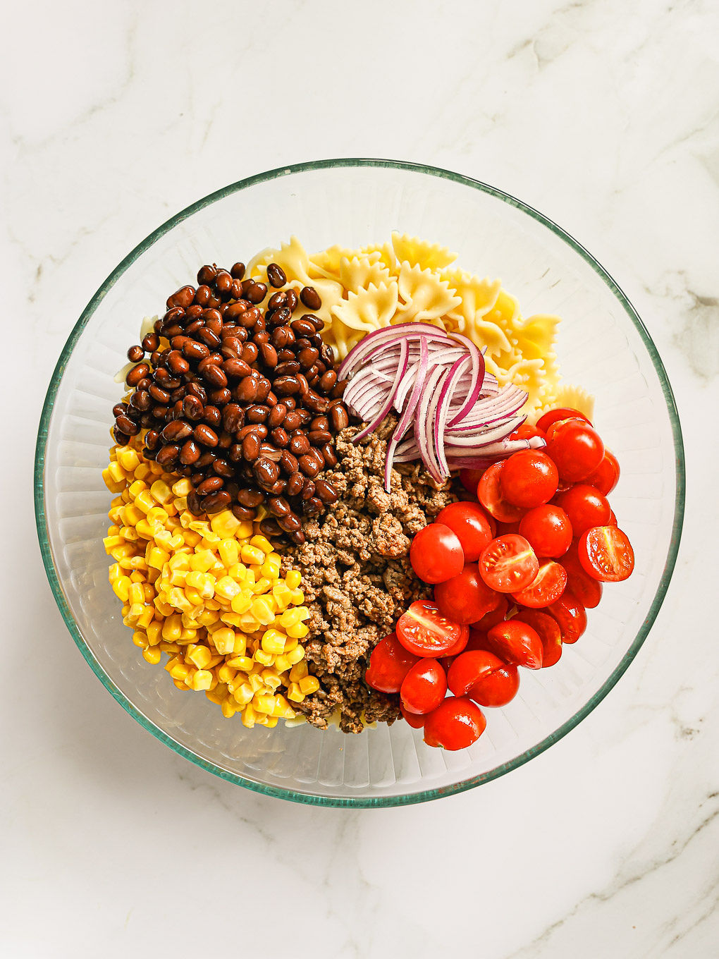 salad ingredients in a glass bowl.