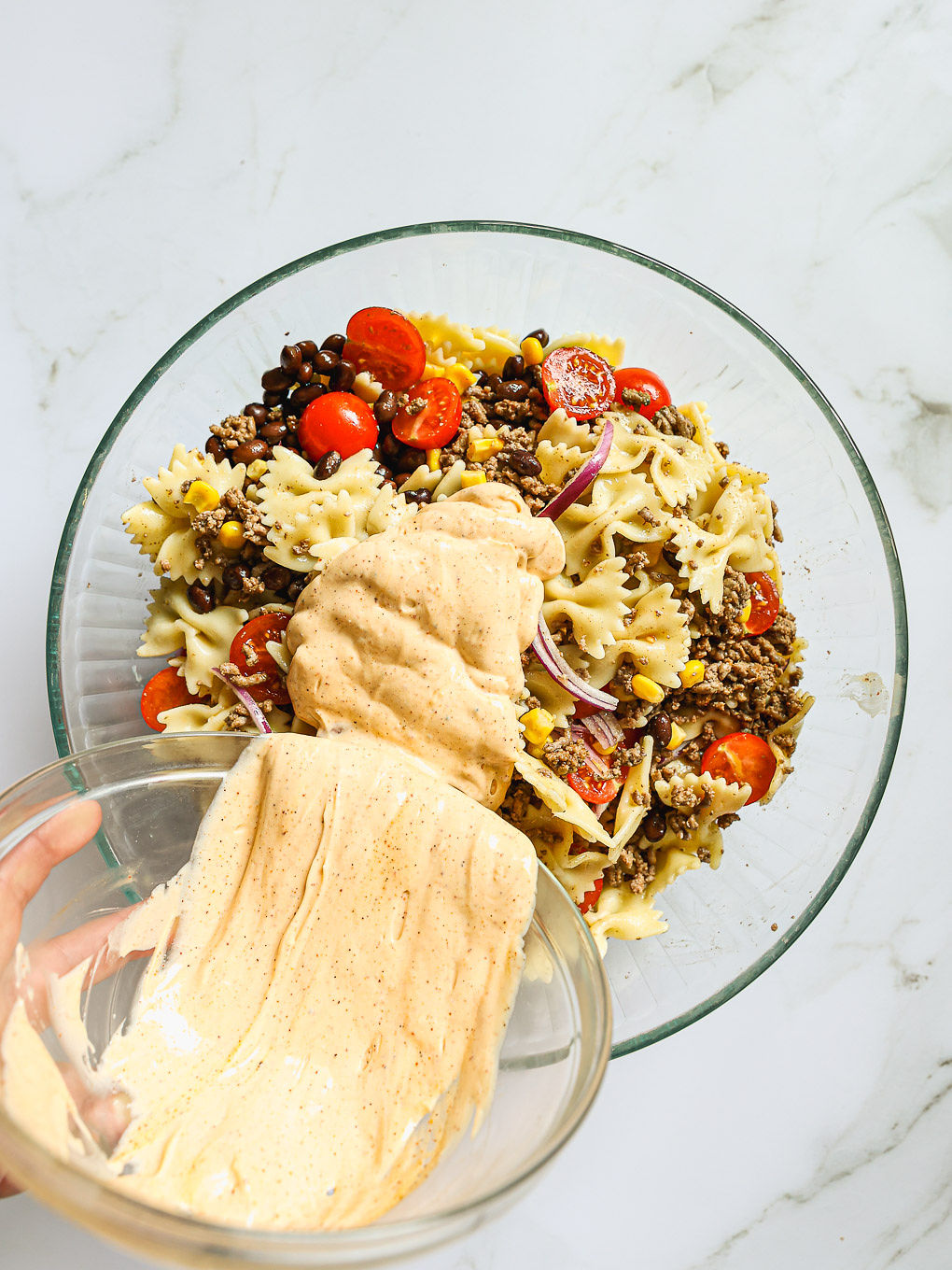 dressing with salad in a glass bowl.