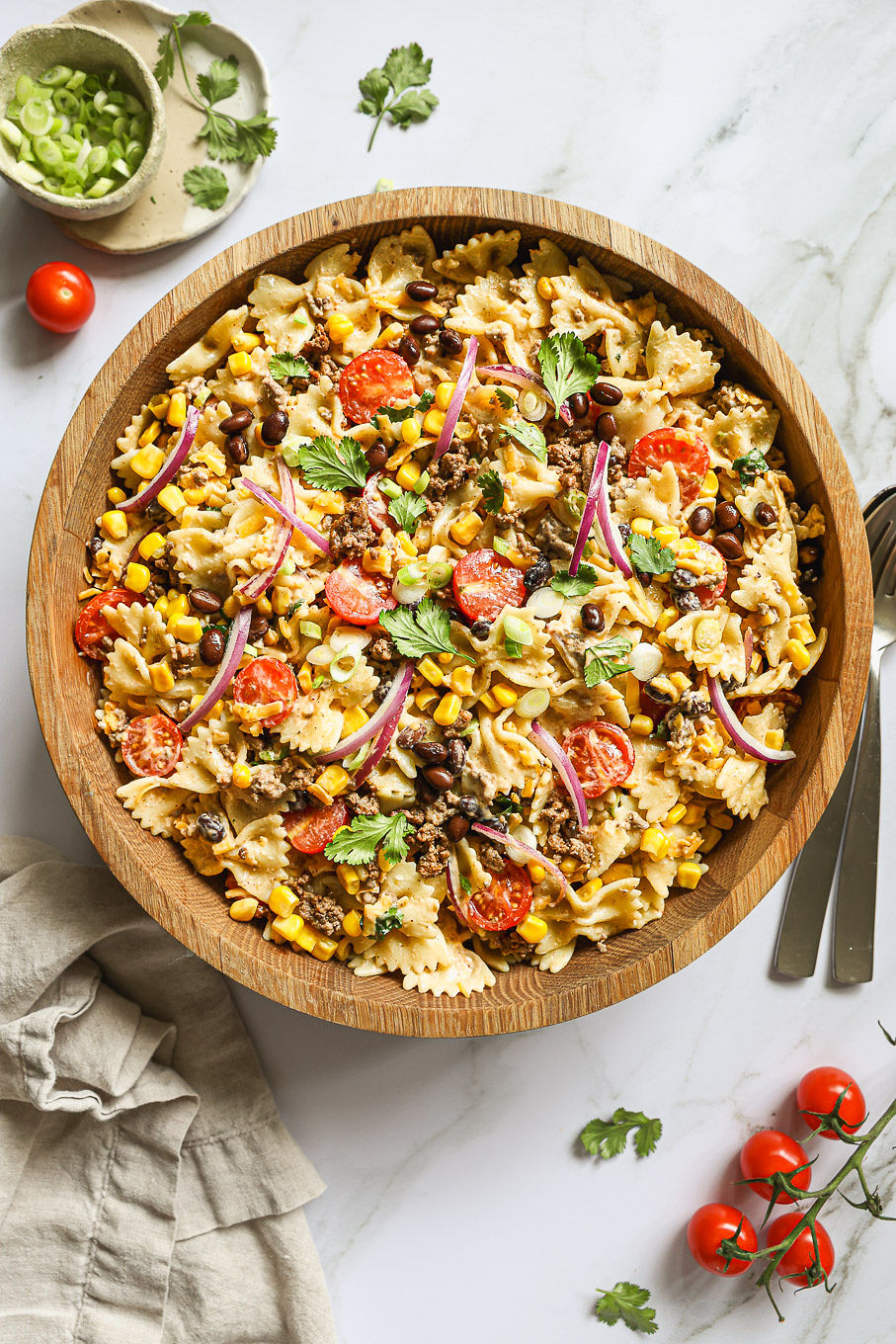 pasta with ground beef and creamy dressing in a wooden bowl.