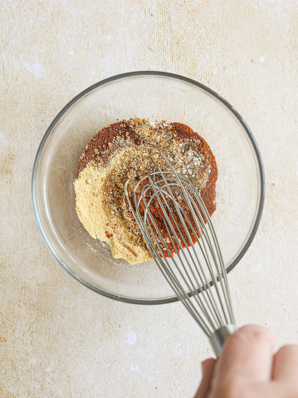 spice mixture in a glass mixing bowl.