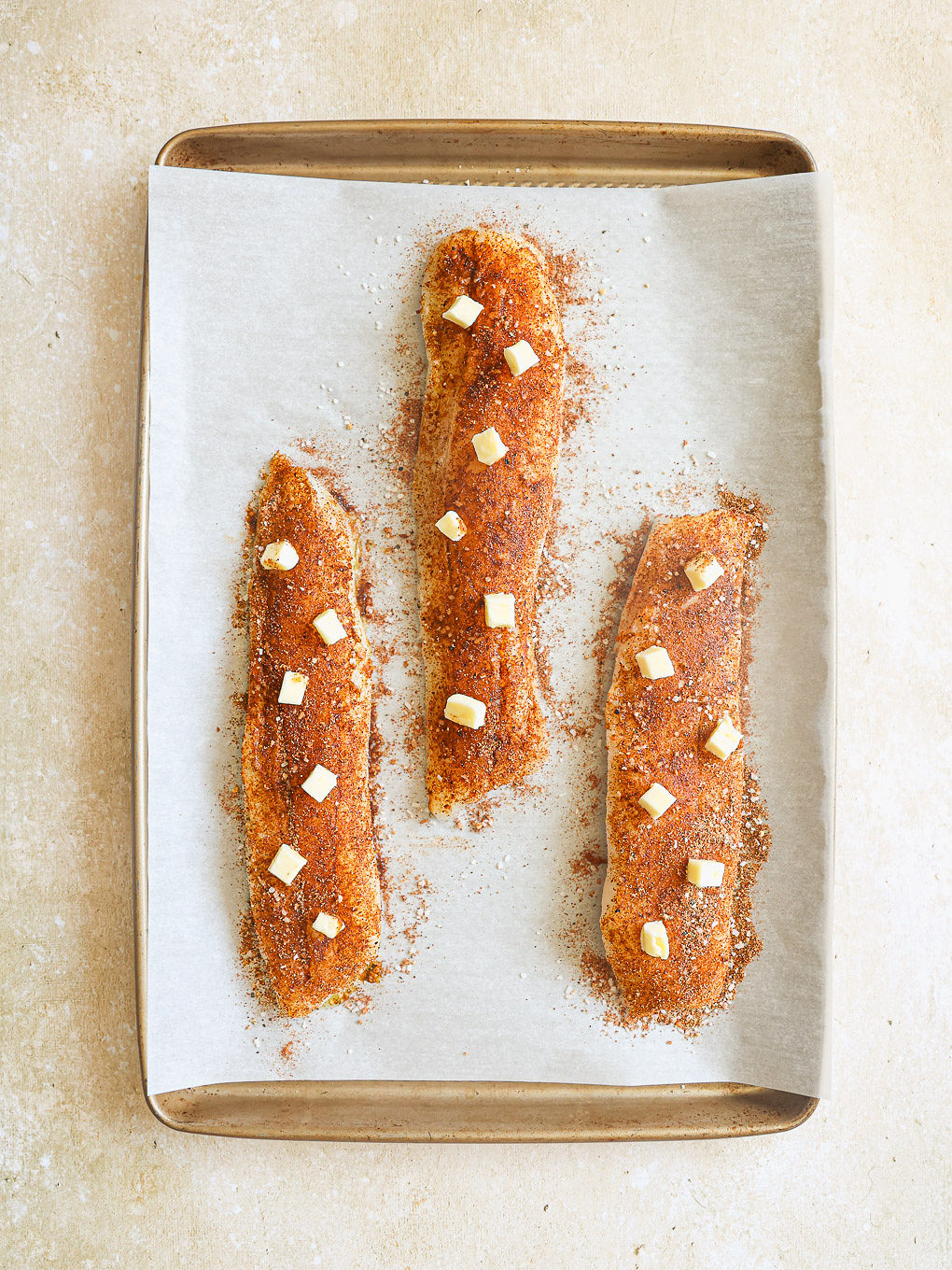 cod fillets topped with dots of butter.
