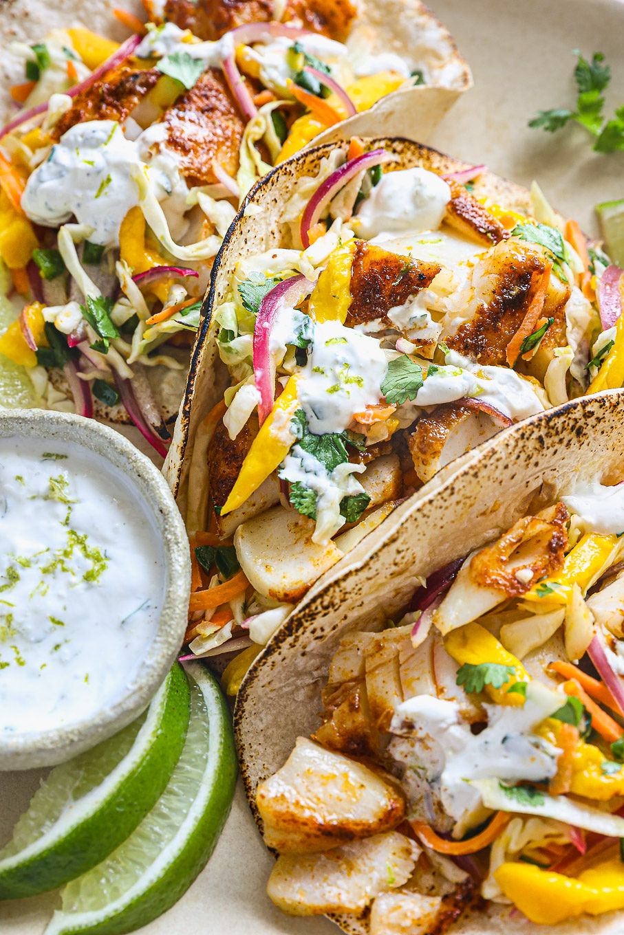 close up of tacos with white fish and coleslaw mix.