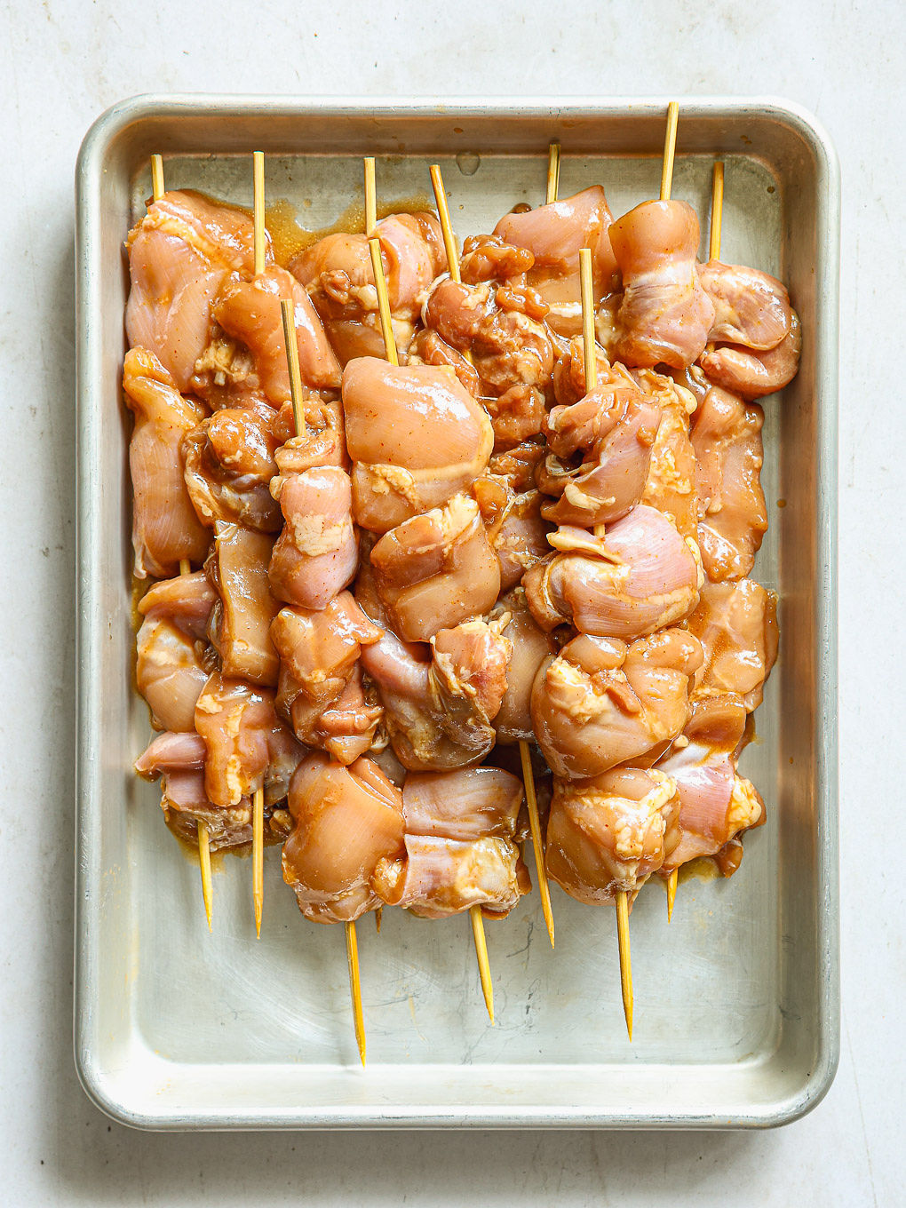 chicken pieces threaded onto skewers.