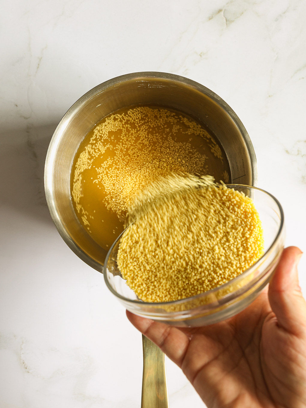 dry couscous in a pan.