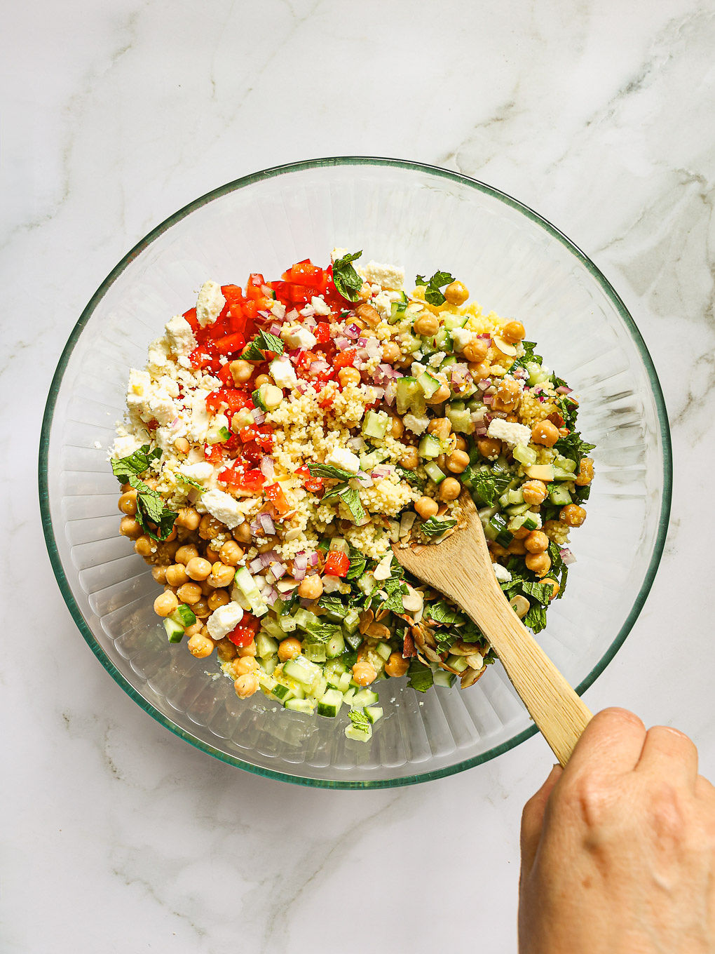 mixed salad in a serving bowl with a spoon.