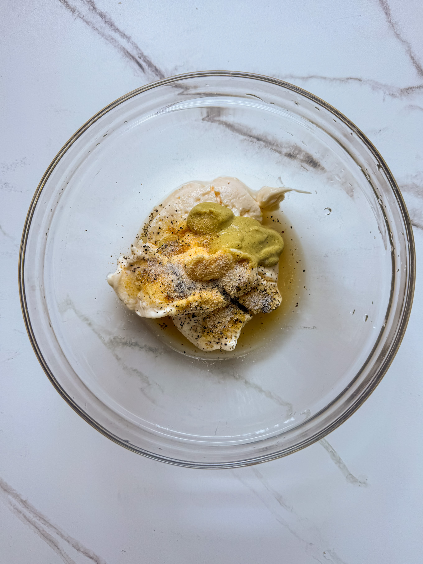 dressing ingredients in a glass bowl.