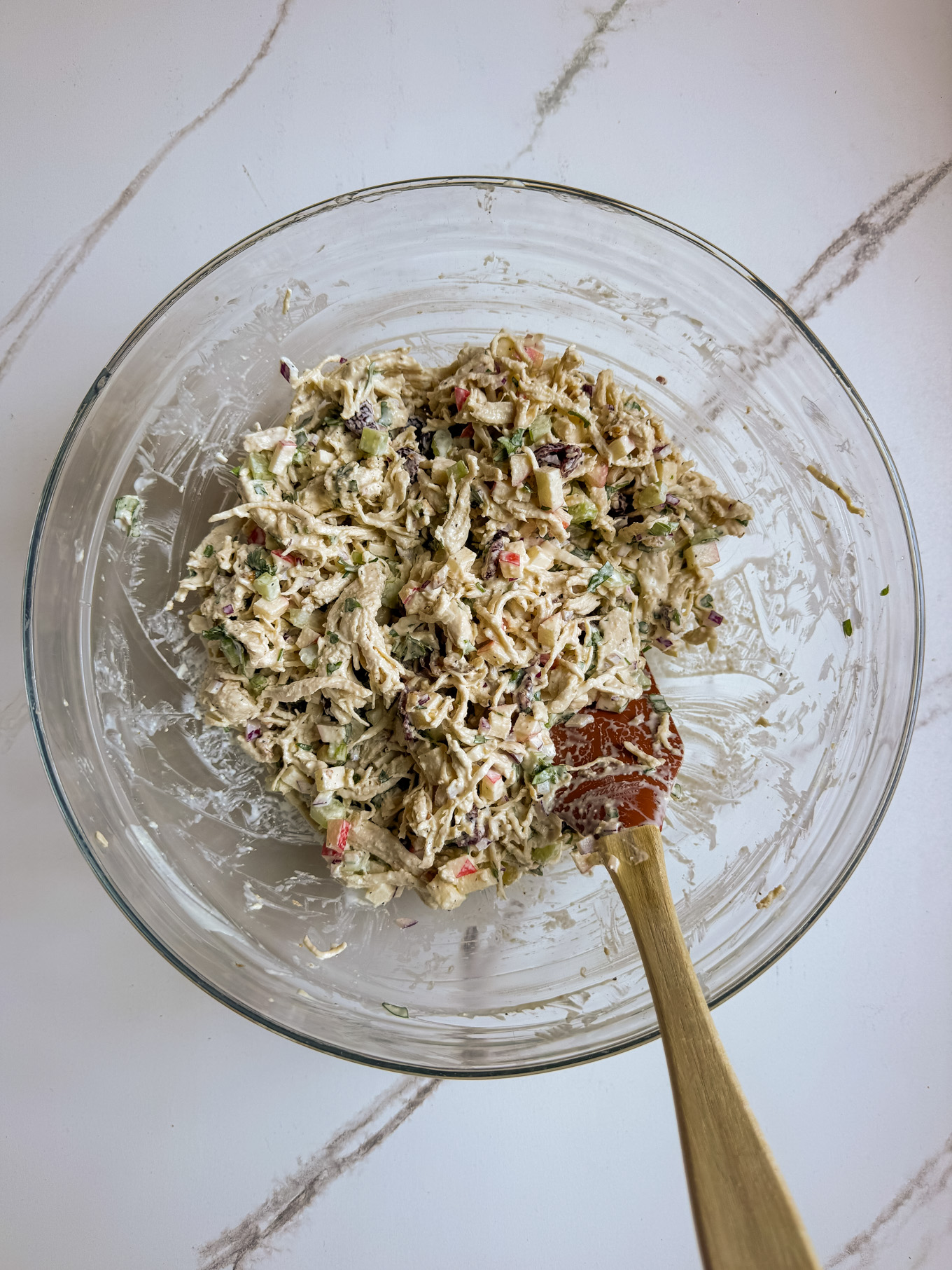 chicken salad mixed in a glass bowl.