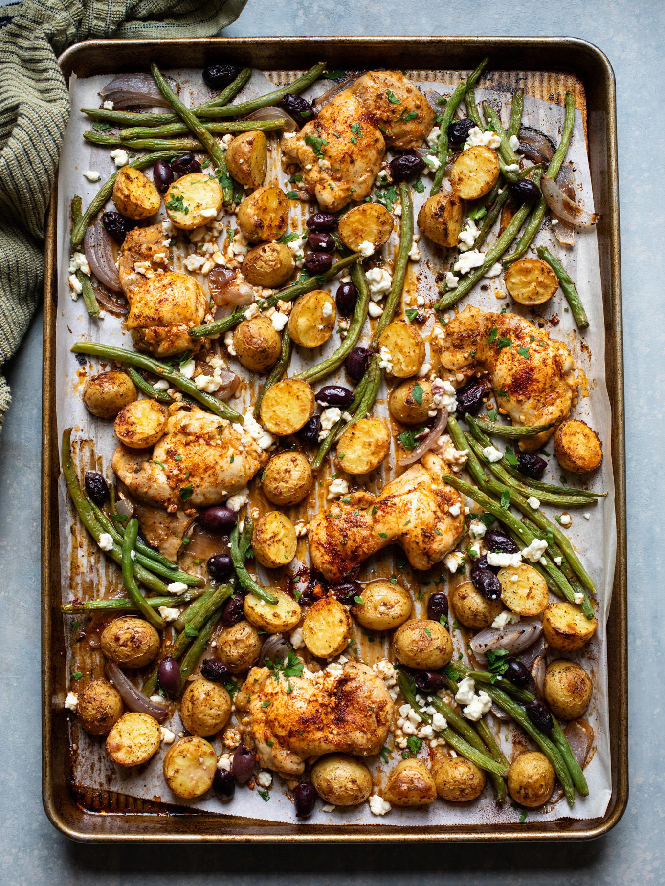 roasted chicken, potatoes, green beans on a sheet pan.