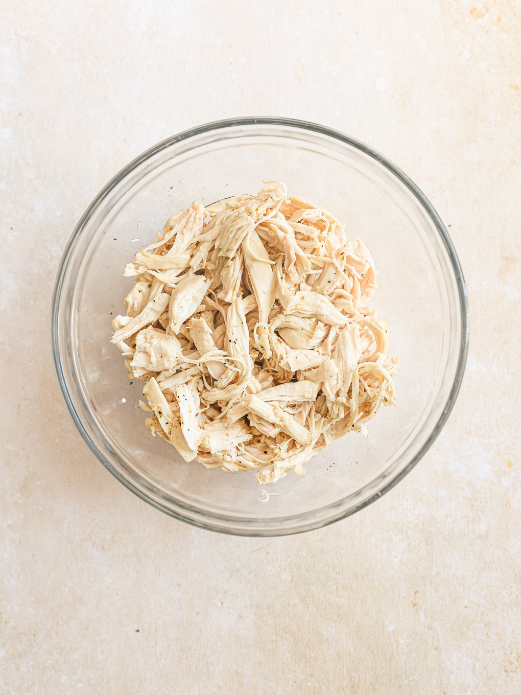 shredded chicken in a glass bowl.