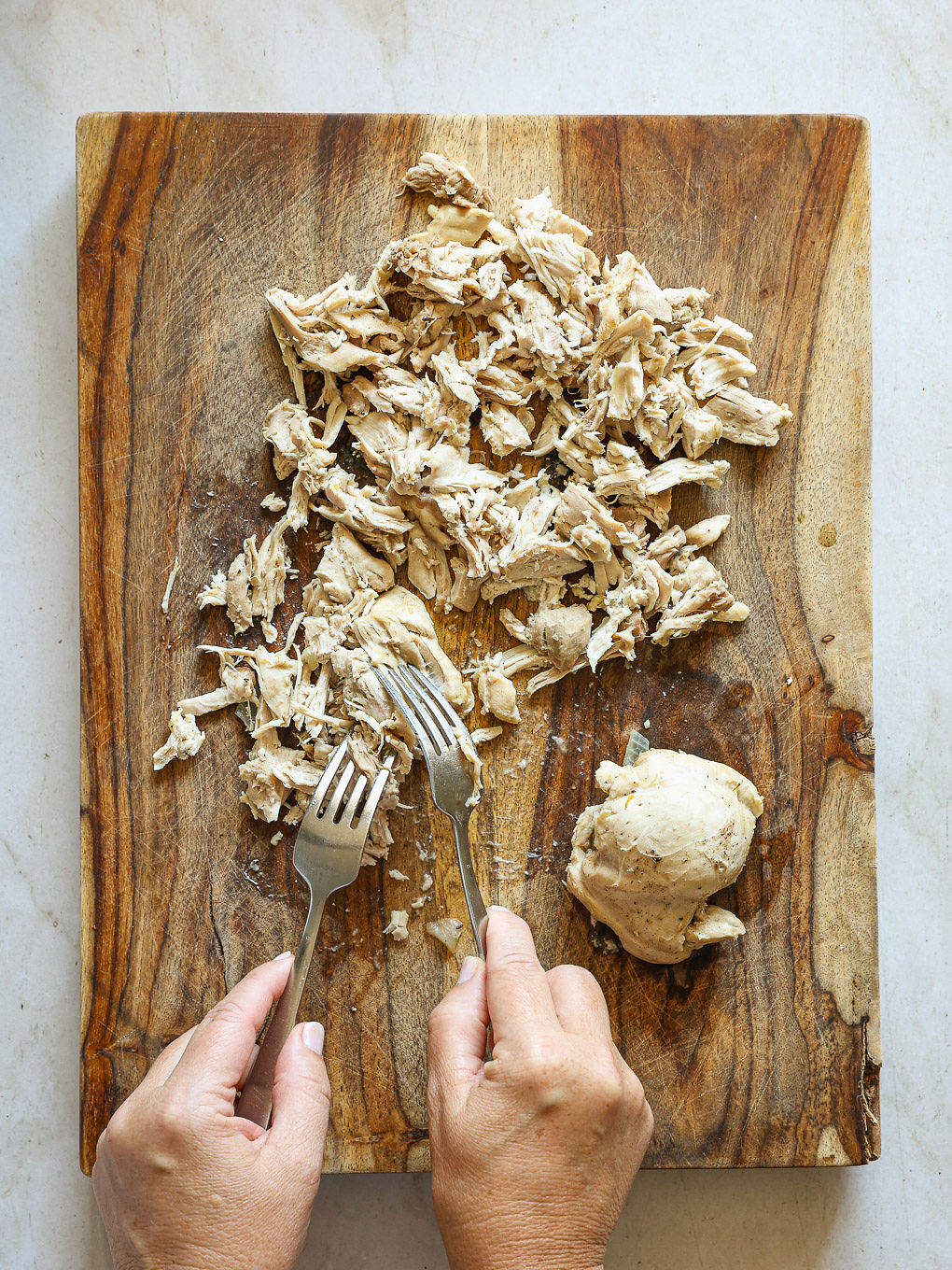 shredded chicken on a cutting board.