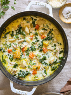 creamy gnocchi soup in a white dutch oven.