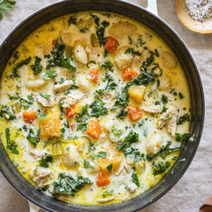 creamy gnocchi soup in a white dutch oven.
