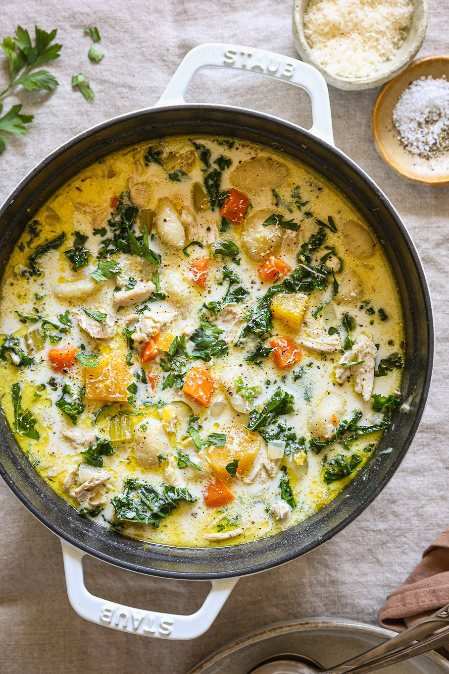 creamy gnocchi soup in a white dutch oven.