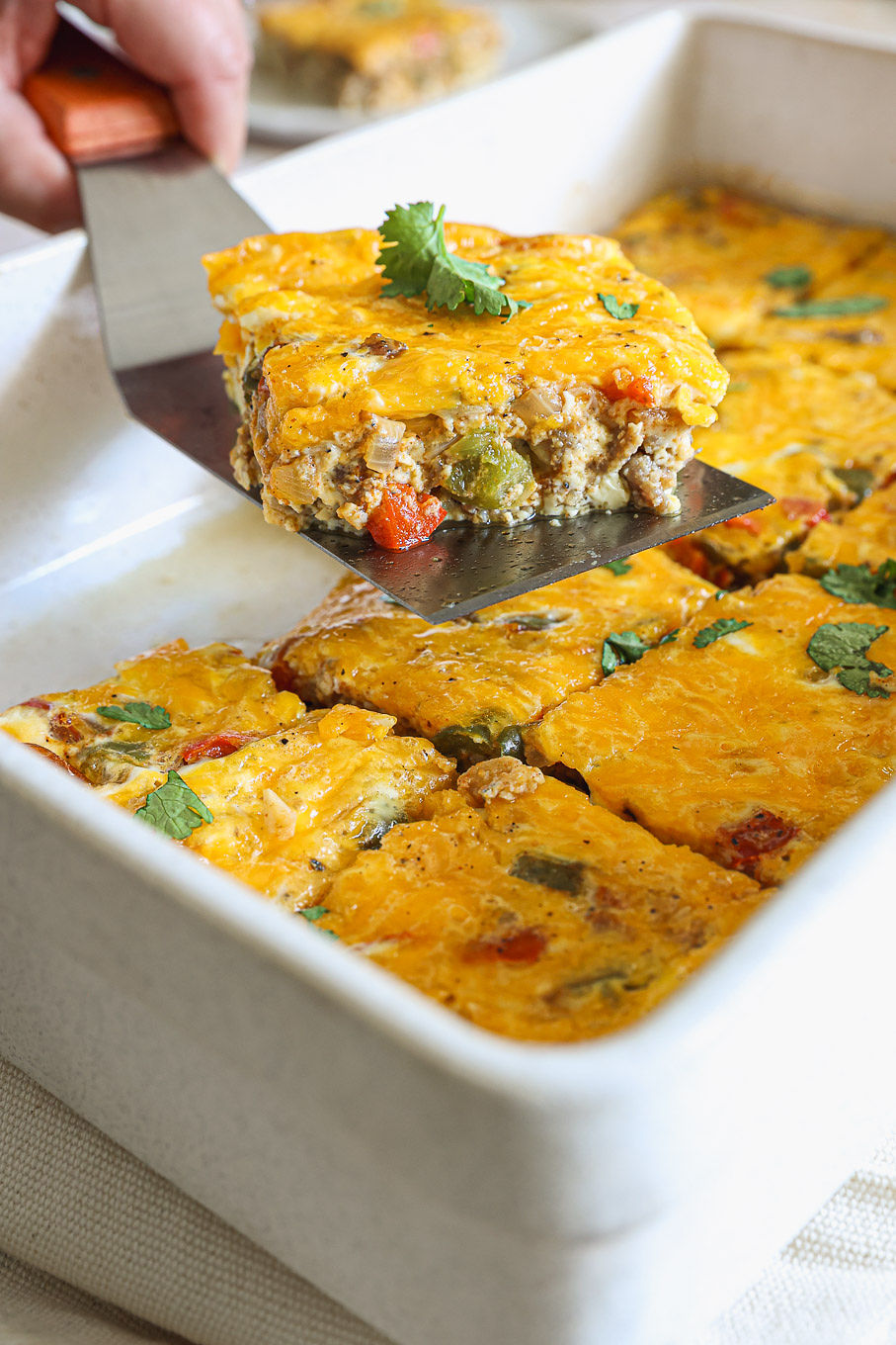 side view of baked egg casserole in a white baking dish.