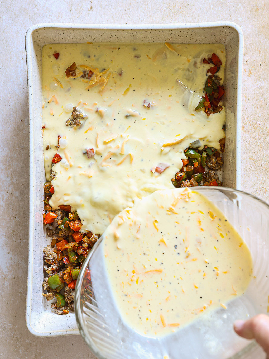 egg and sausage mixture in a white casserole.