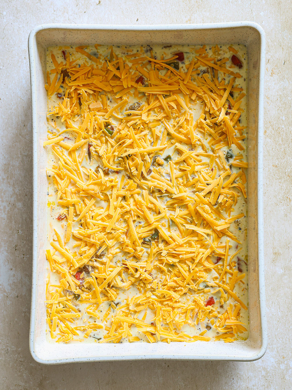egg mixture topped with shredded cheese.