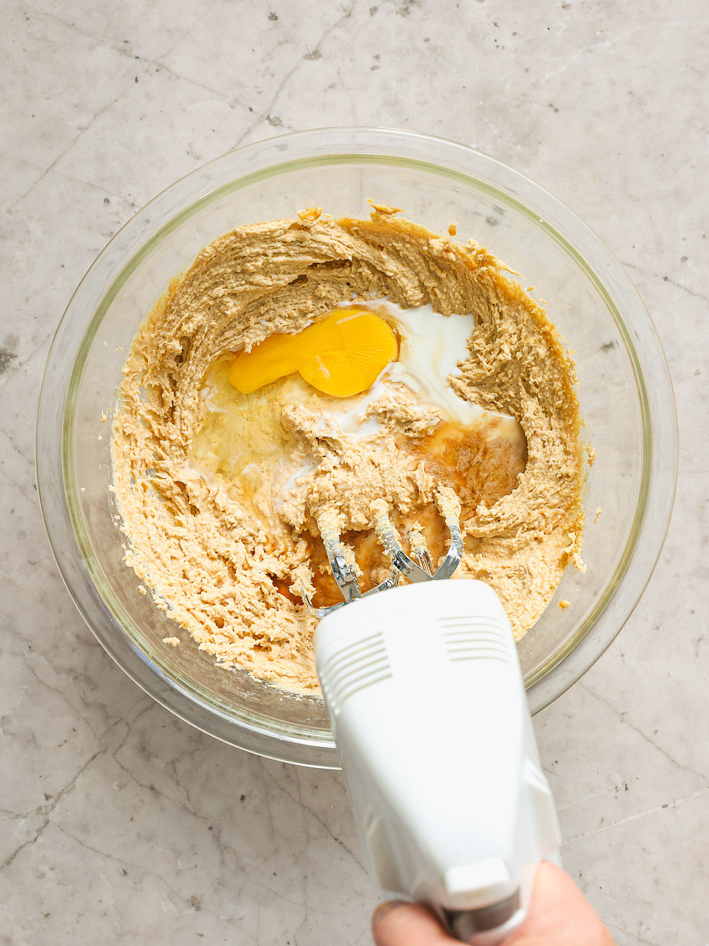 egg in batter in a glass bowl.