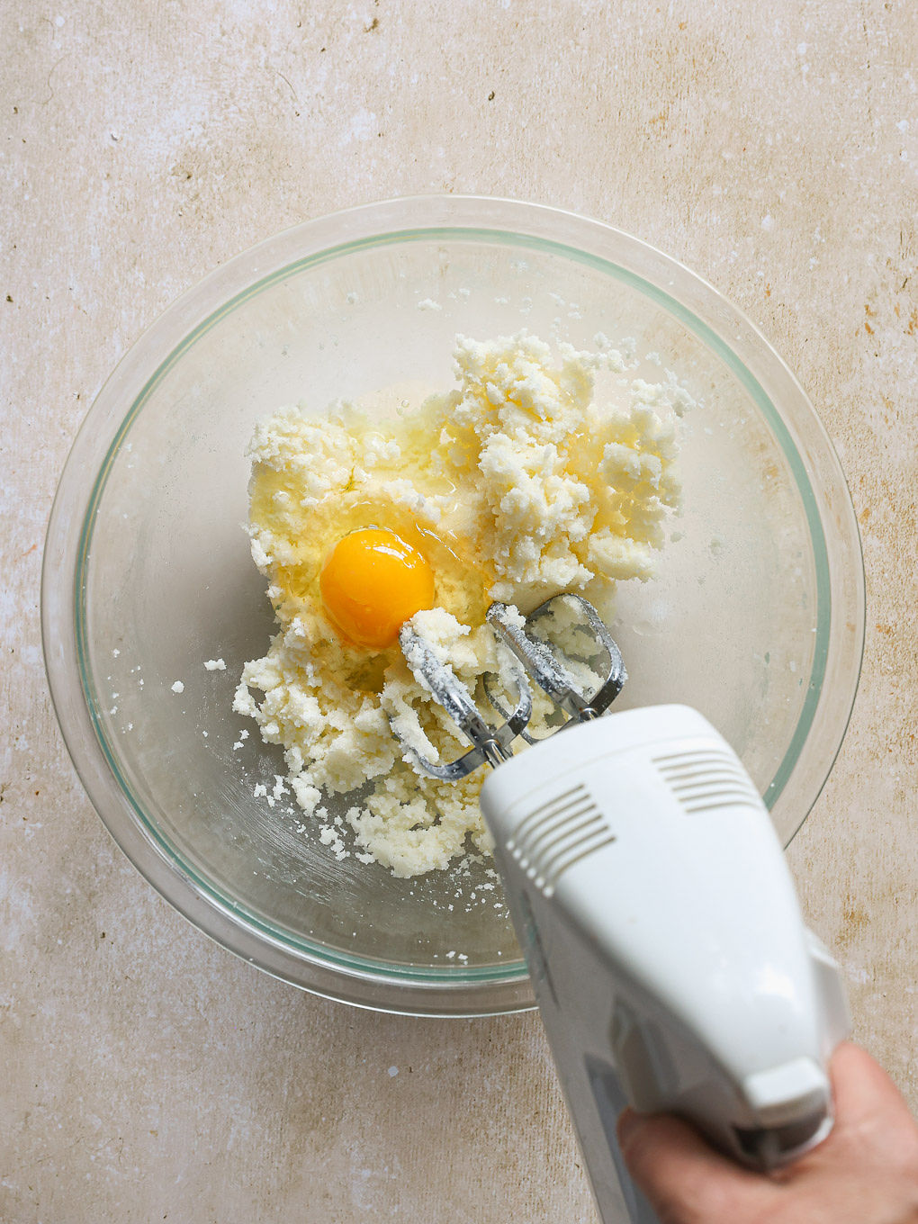 egg with butter in a glass mixing bowl.