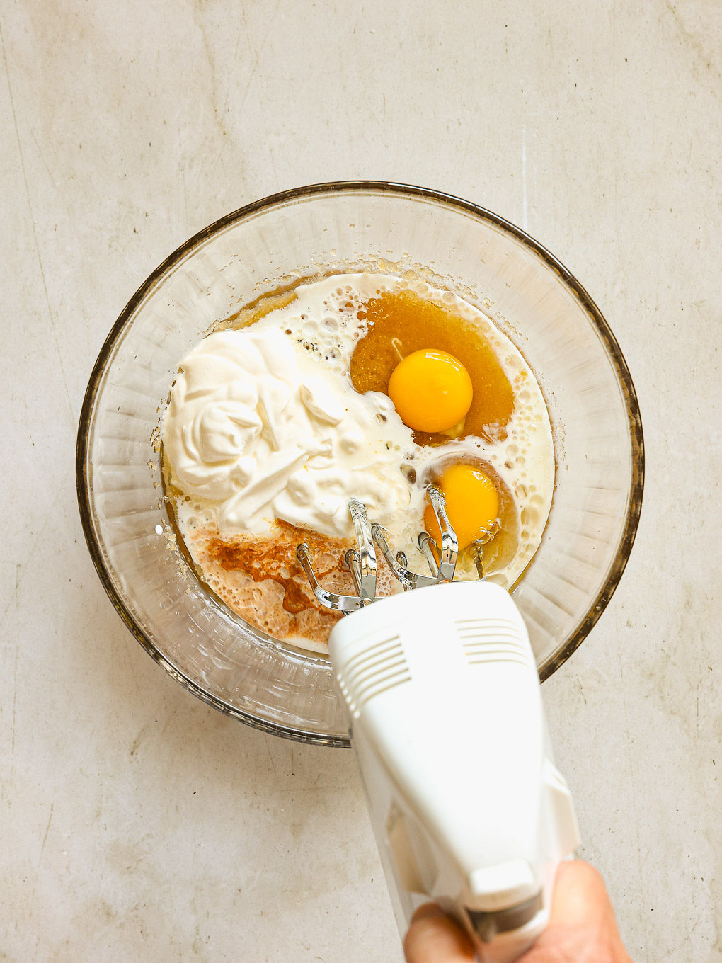 eggs with sour cream in mixing bowl.