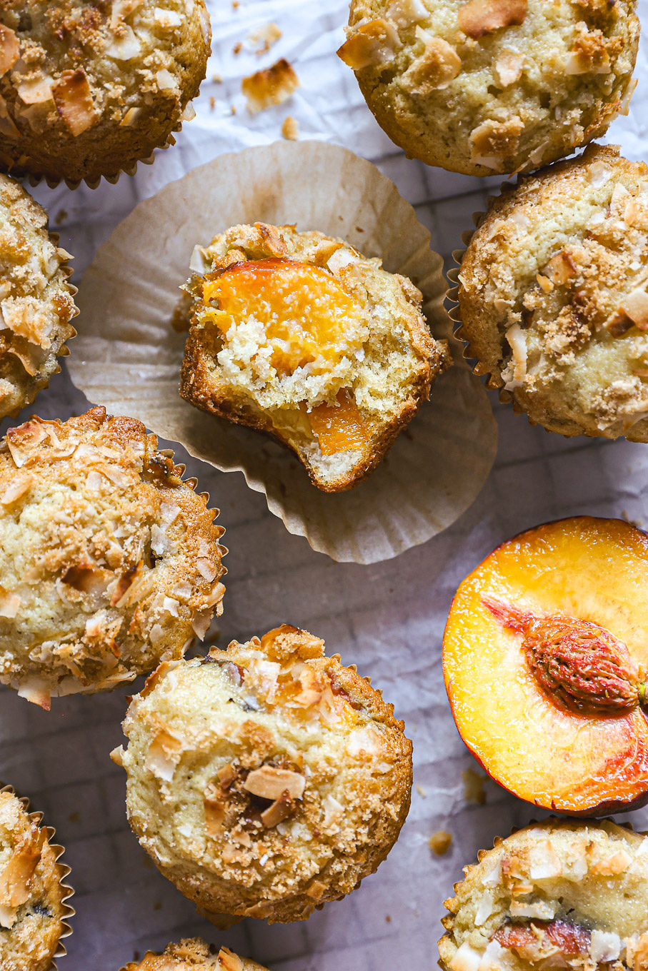 muffins with fresh peaches cut open.