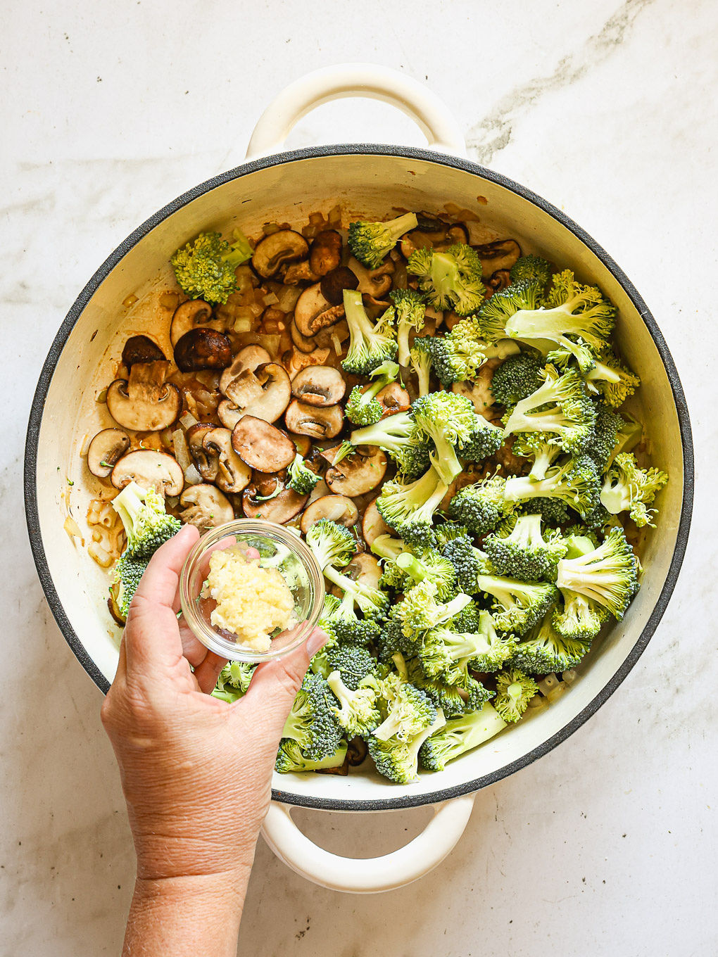 broccoli and mushrooms with garlic in skillet.