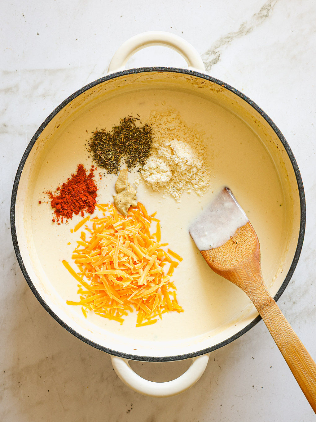 spices and cheese whisked into sauce.