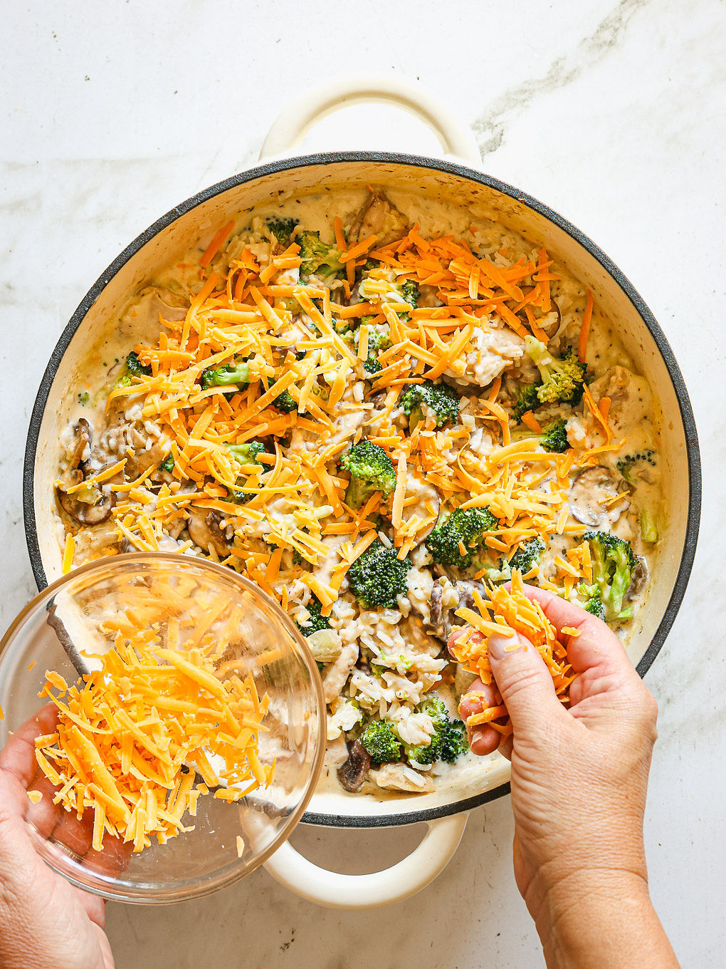 rice and chicken casserole topped with shredded cheddar cheese.