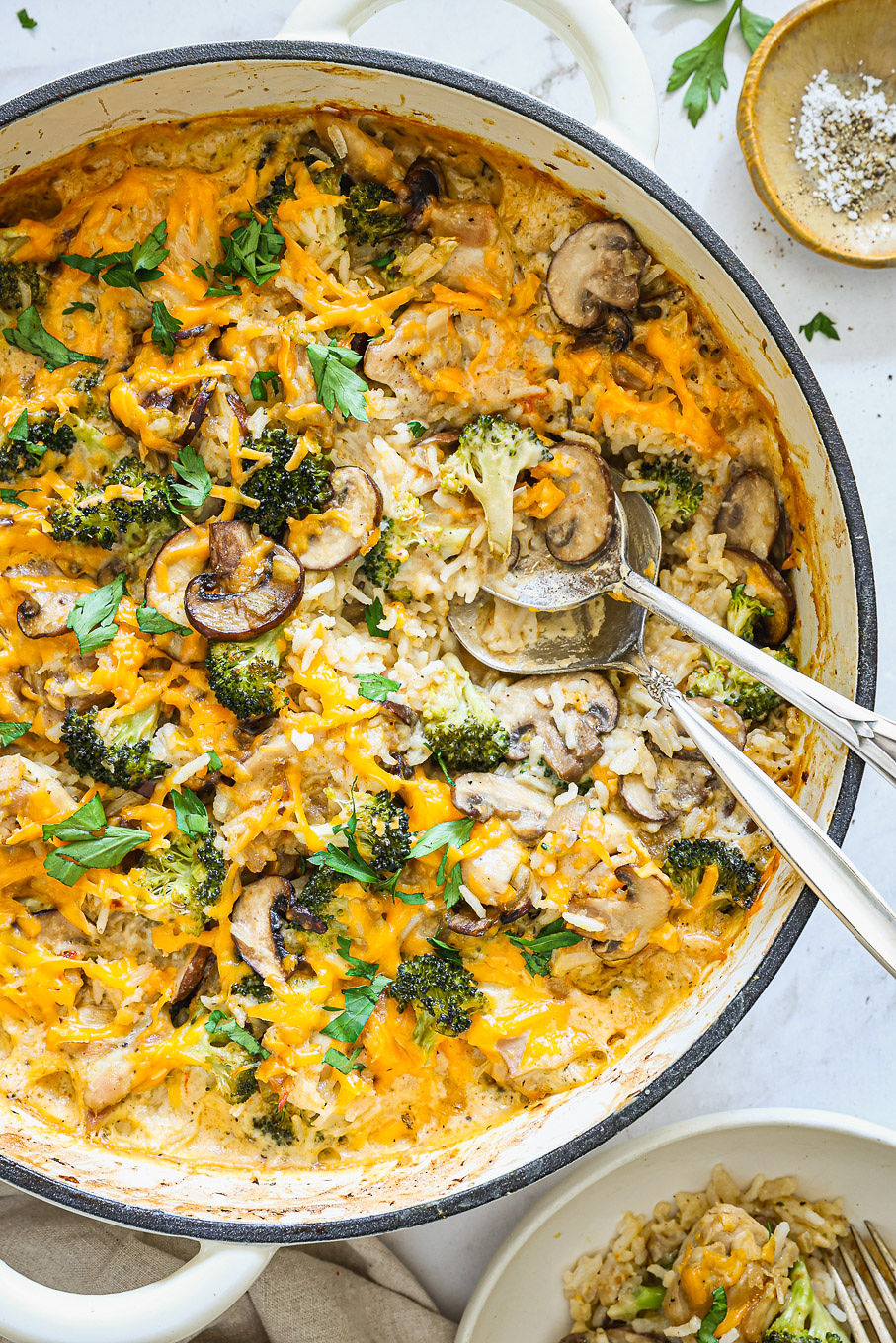 baked chicken rice casserole in a white saute pan.