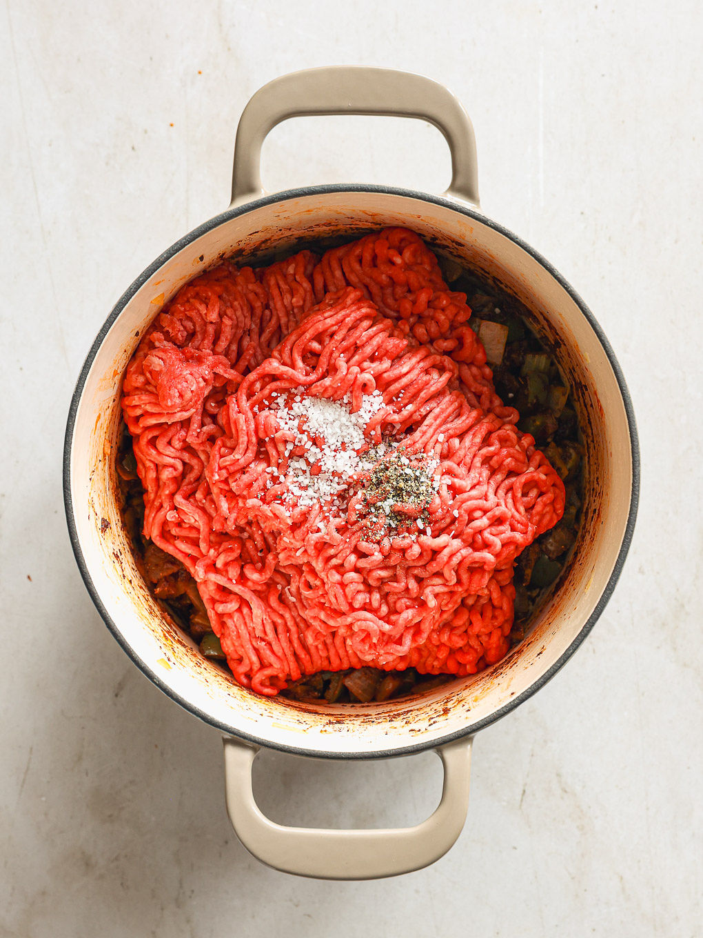 ground beef raw inside a pot.